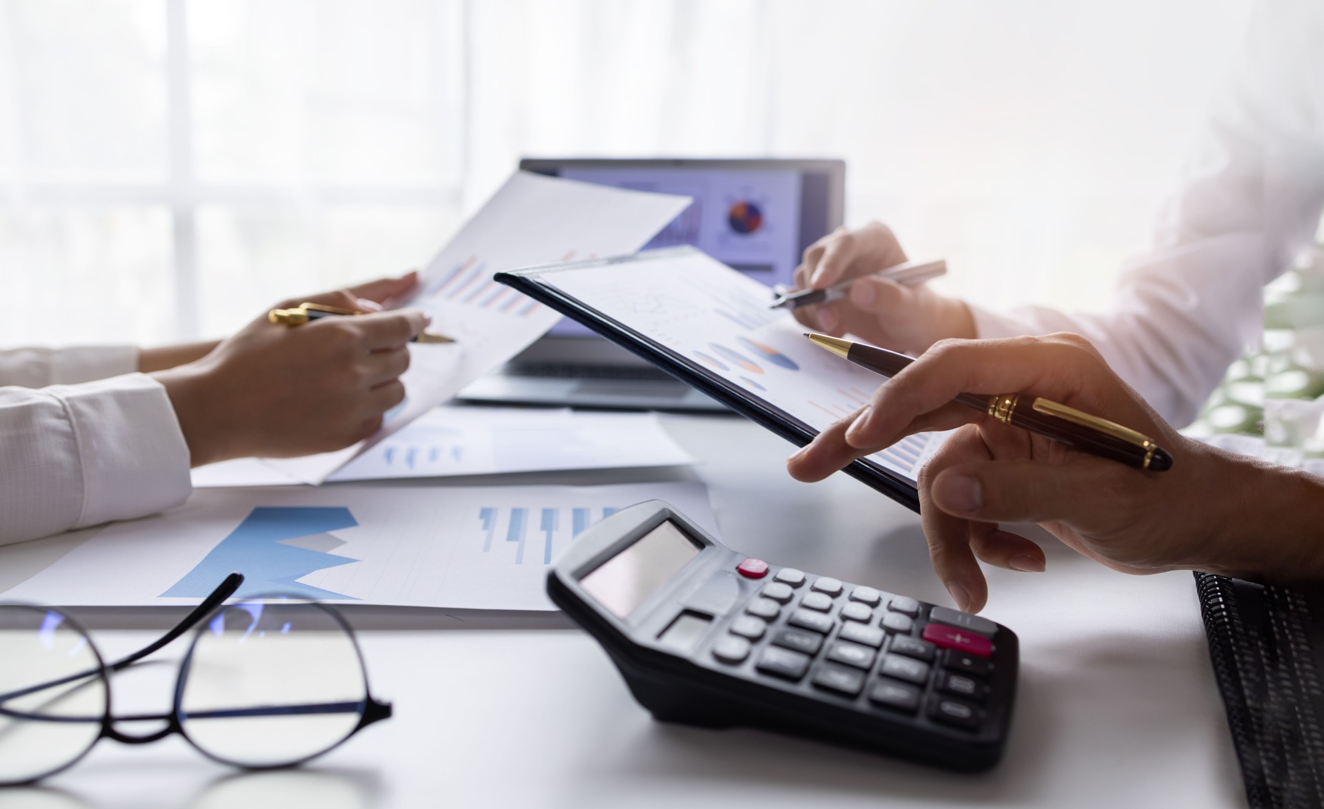 Marketing Financial analyst analysis business financial report on digital tablet during discussion at meeting of corporate showing the results of their successful teamwork., business meeting concept,
